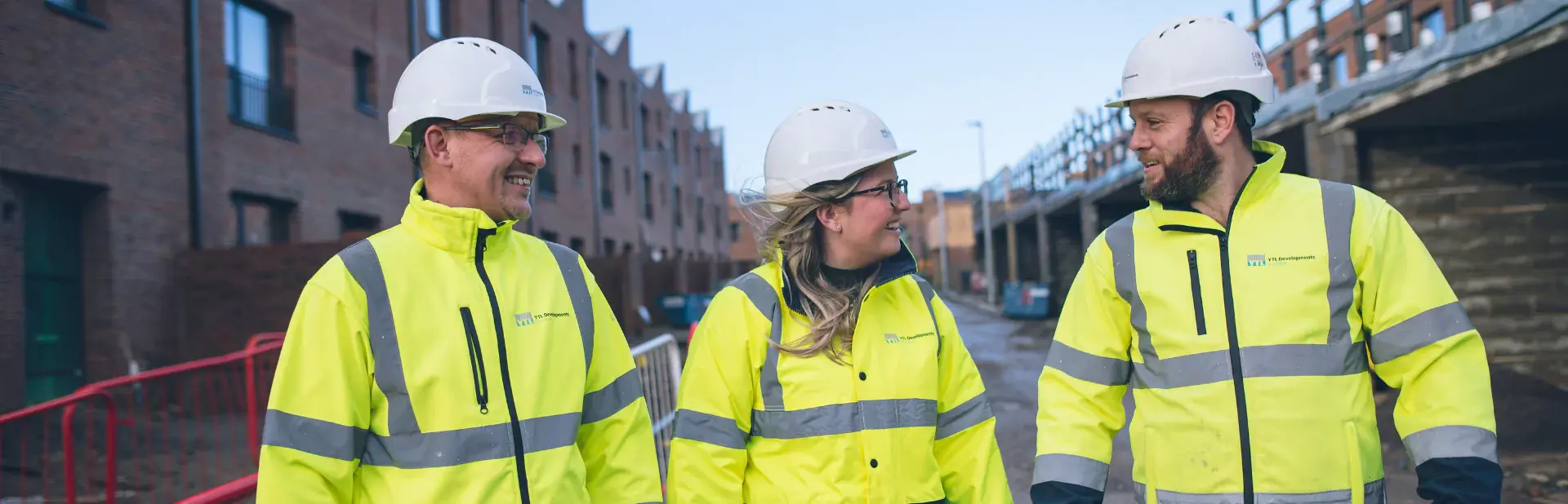 Image of three YTL employees smiling