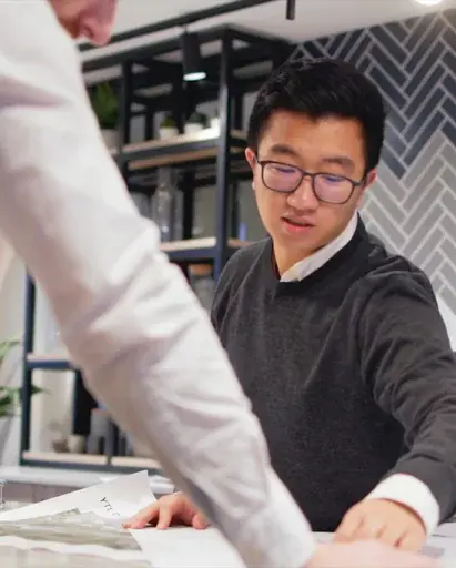 YTL Developments employee pointing at plans on paper
