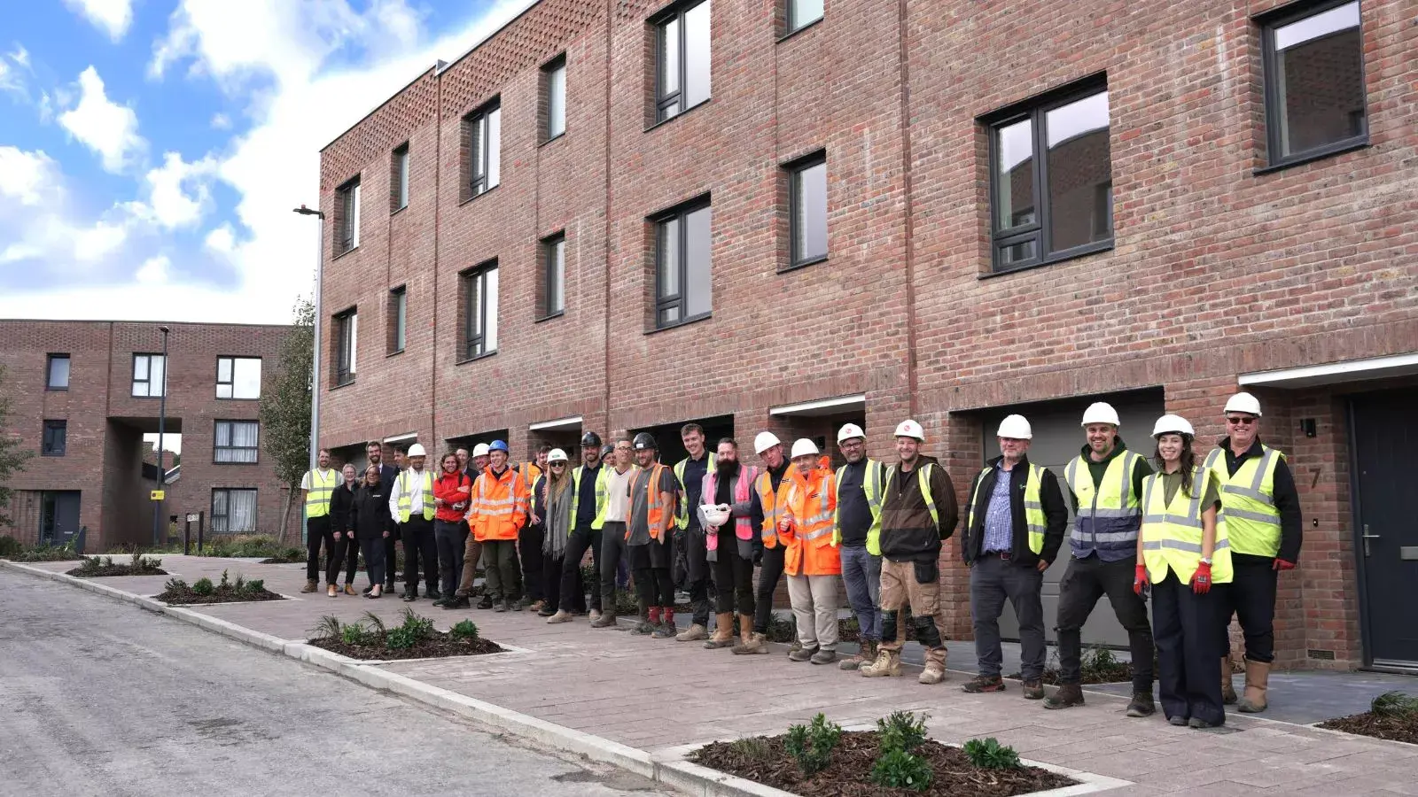 YTL Developments, YTL Construction and SNG stand outside affordable housing on Smart Street at Brabazon in North Bristol. 